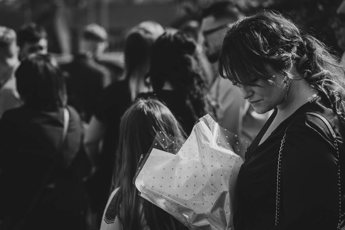 Woman holding flowers at funeral service