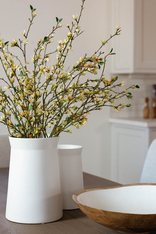 Detail of white vase with flowers